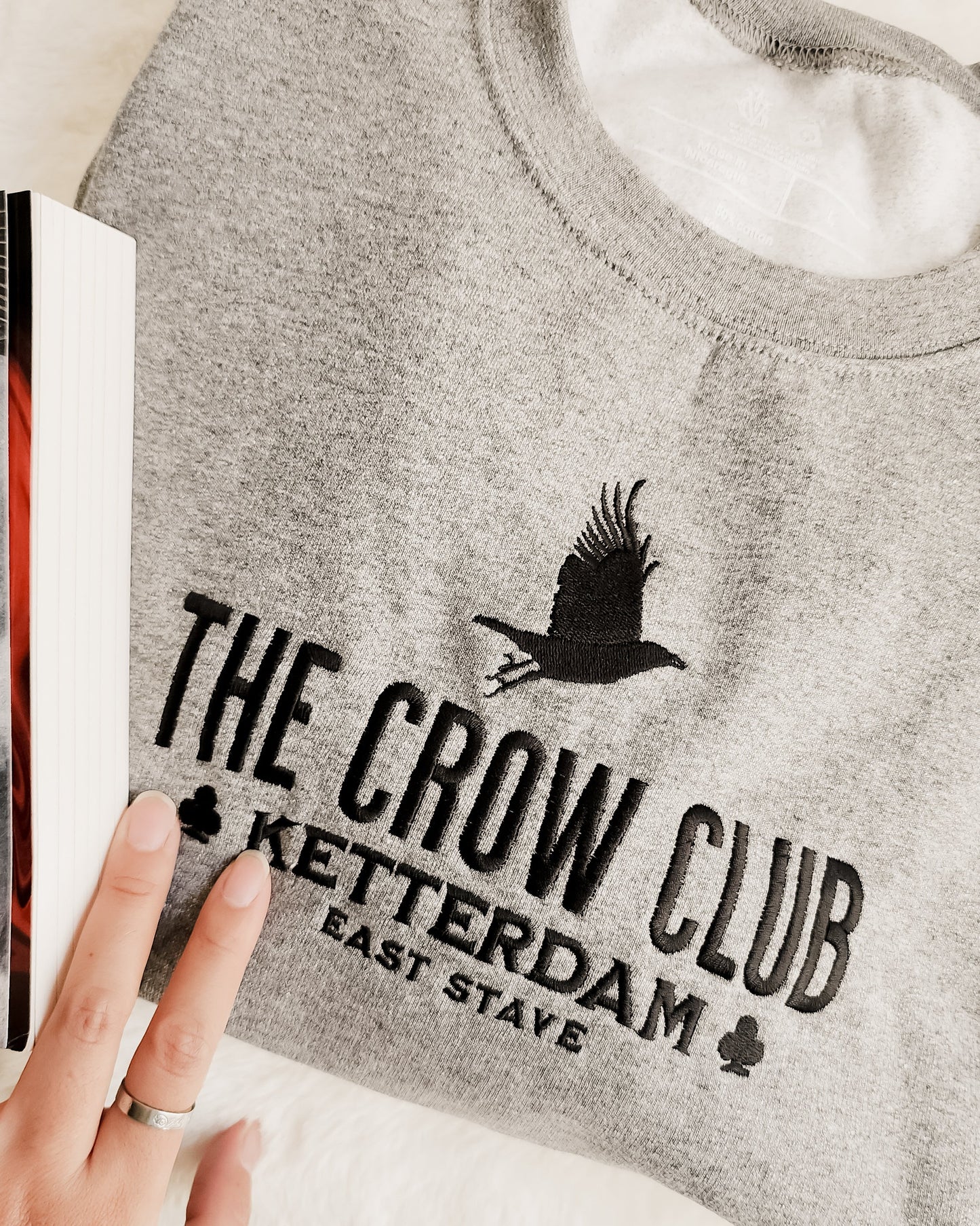 The Crow Club Embroidered Sweatshirt - The Bean Workshop - Book Lover Gift, Bookish Sweatshirt, Cozy Aesthetic, East Stave, Fantasy Book Merch, Grishaverse fan gift, Kaz Brekker, Ketterdam merch for readers, Leigh Bardugo bookish apparel, Literary Logo, Six of Crows cozy sweater, The Crow Club sweatshirt, The Dregs