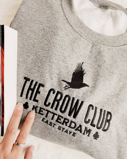 The Crow Club Embroidered Sweatshirt - The Bean Workshop - Book Lover Gift, Bookish Sweatshirt, Cozy Aesthetic, East Stave, Fantasy Book Merch, Grishaverse fan gift, Kaz Brekker, Ketterdam merch for readers, Leigh Bardugo bookish apparel, Literary Logo, Six of Crows cozy sweater, The Crow Club sweatshirt, The Dregs