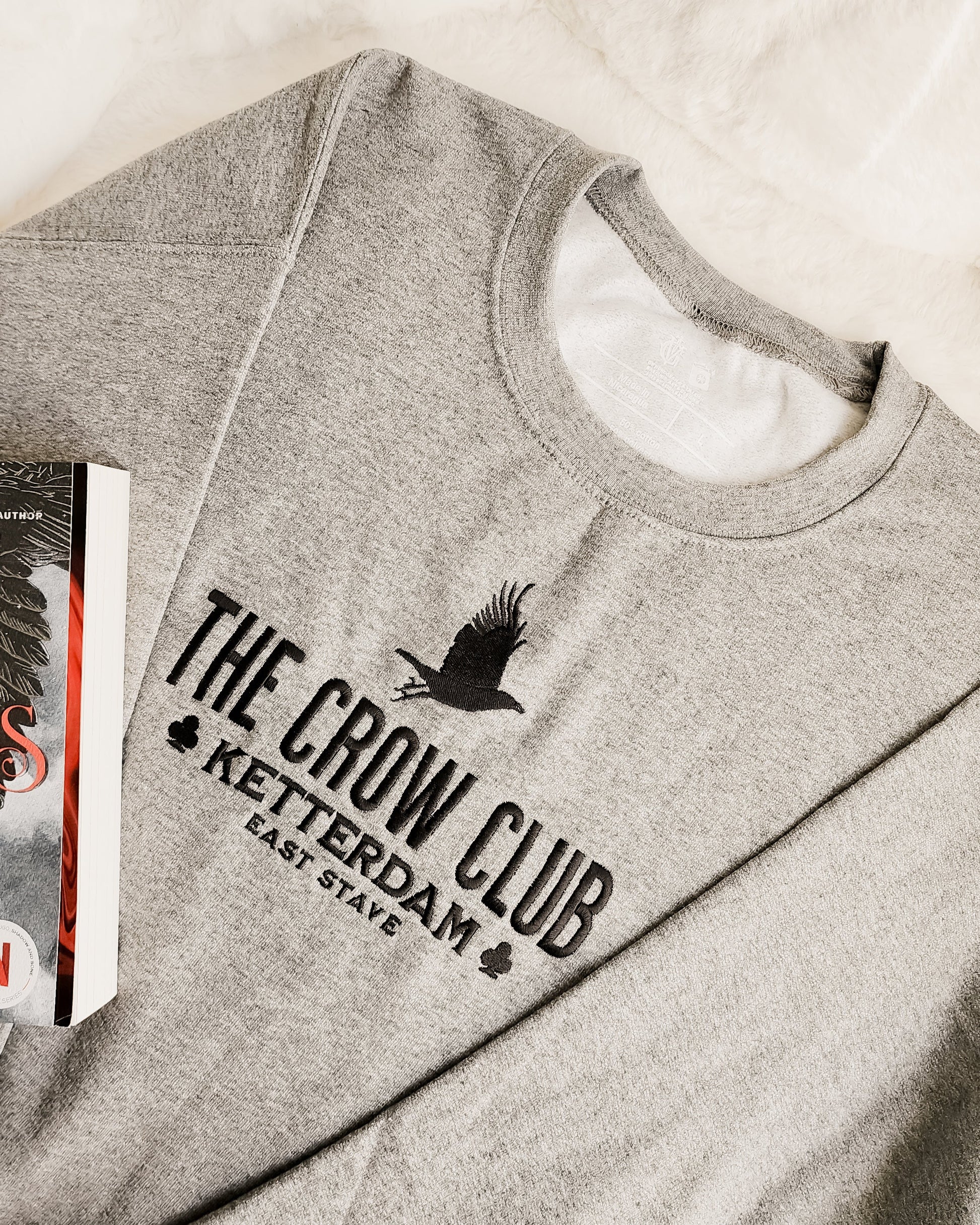 The Crow Club Embroidered Sweatshirt - The Bean Workshop - Book Lover Gift, Bookish Sweatshirt, Cozy Aesthetic, East Stave, Fantasy Book Merch, Grishaverse fan gift, Kaz Brekker, Ketterdam merch for readers, Leigh Bardugo bookish apparel, Literary Logo, Six of Crows cozy sweater, The Crow Club sweatshirt, The Dregs