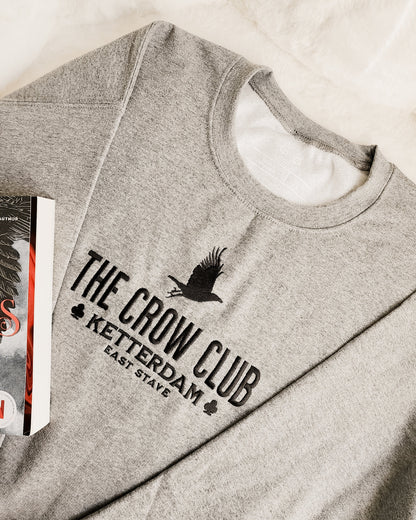 The Crow Club Embroidered Sweatshirt - The Bean Workshop - Book Lover Gift, Bookish Sweatshirt, Cozy Aesthetic, East Stave, Fantasy Book Merch, Grishaverse fan gift, Kaz Brekker, Ketterdam merch for readers, Leigh Bardugo bookish apparel, Literary Logo, Six of Crows cozy sweater, The Crow Club sweatshirt, The Dregs